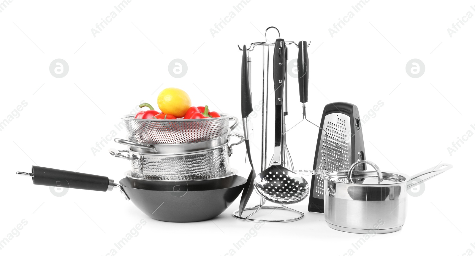 Photo of Dishware, cooking utensils with vegetables and lemon isolated on white