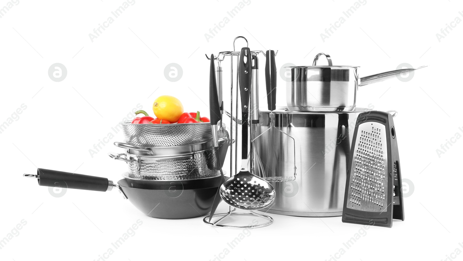 Photo of Dishware, cooking utensils with vegetables and lemon isolated on white