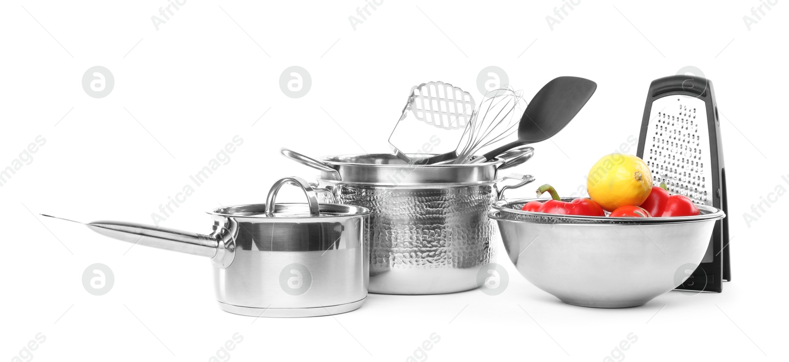 Photo of Dishware, cooking utensils with vegetables and lemon isolated on white