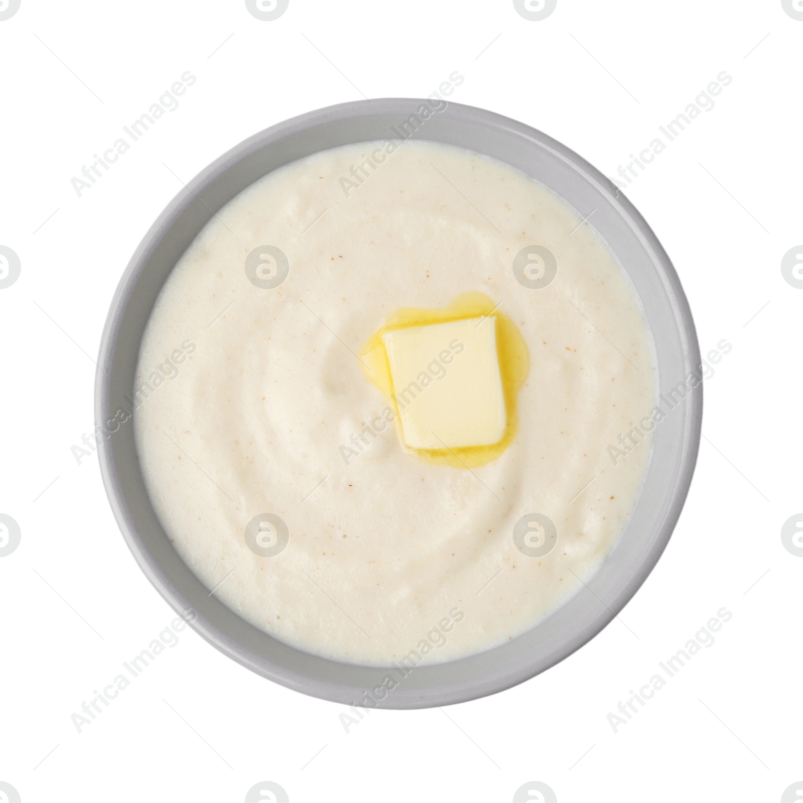 Photo of Tasty cooked semolina porridge with butter isolated on white, top view