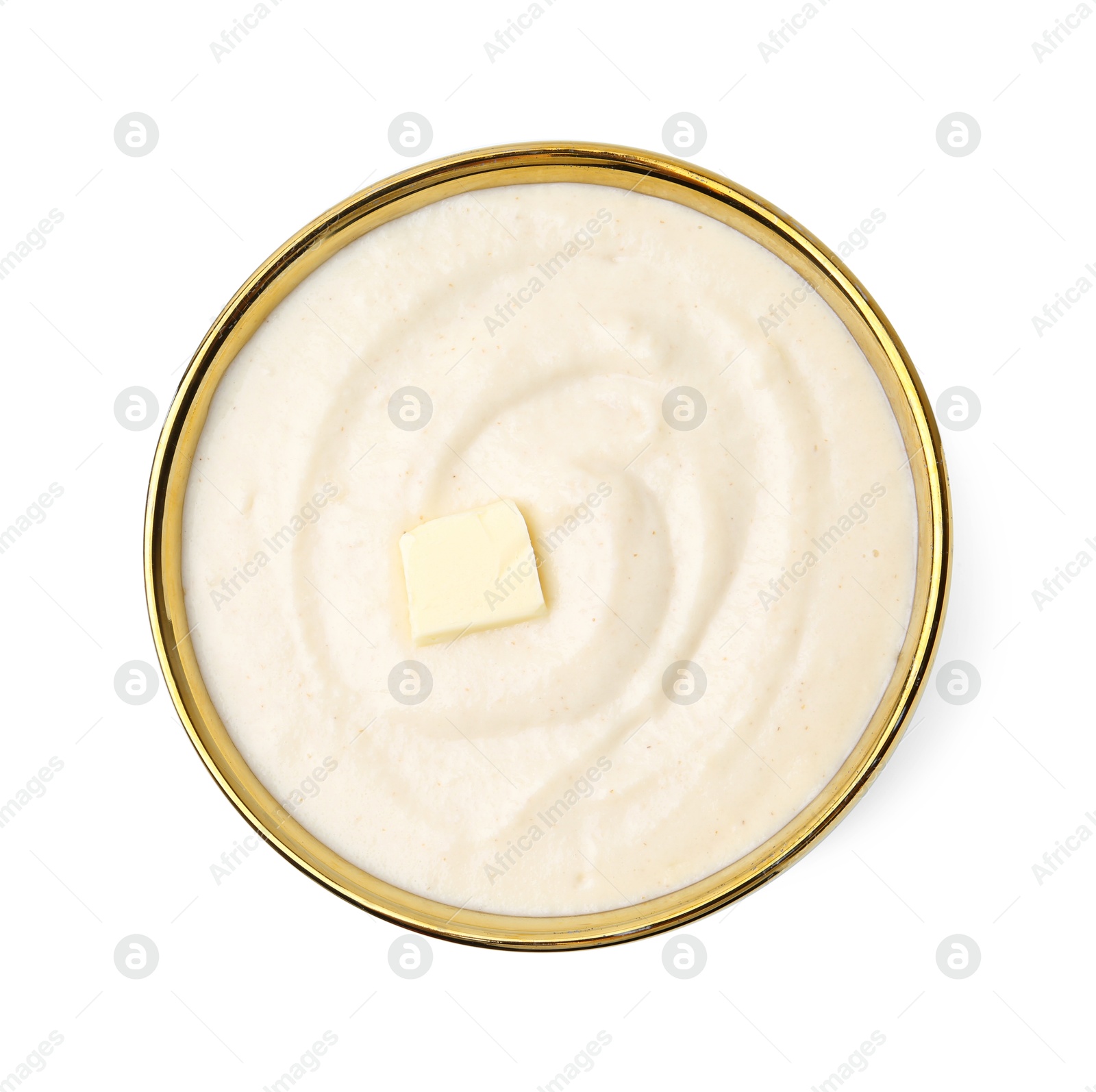 Photo of Tasty cooked semolina porridge with butter isolated on white, top view