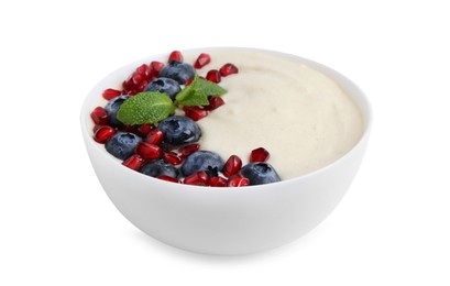 Photo of Tasty cooked semolina porridge with blueberries, pomegranate and mint isolated on white