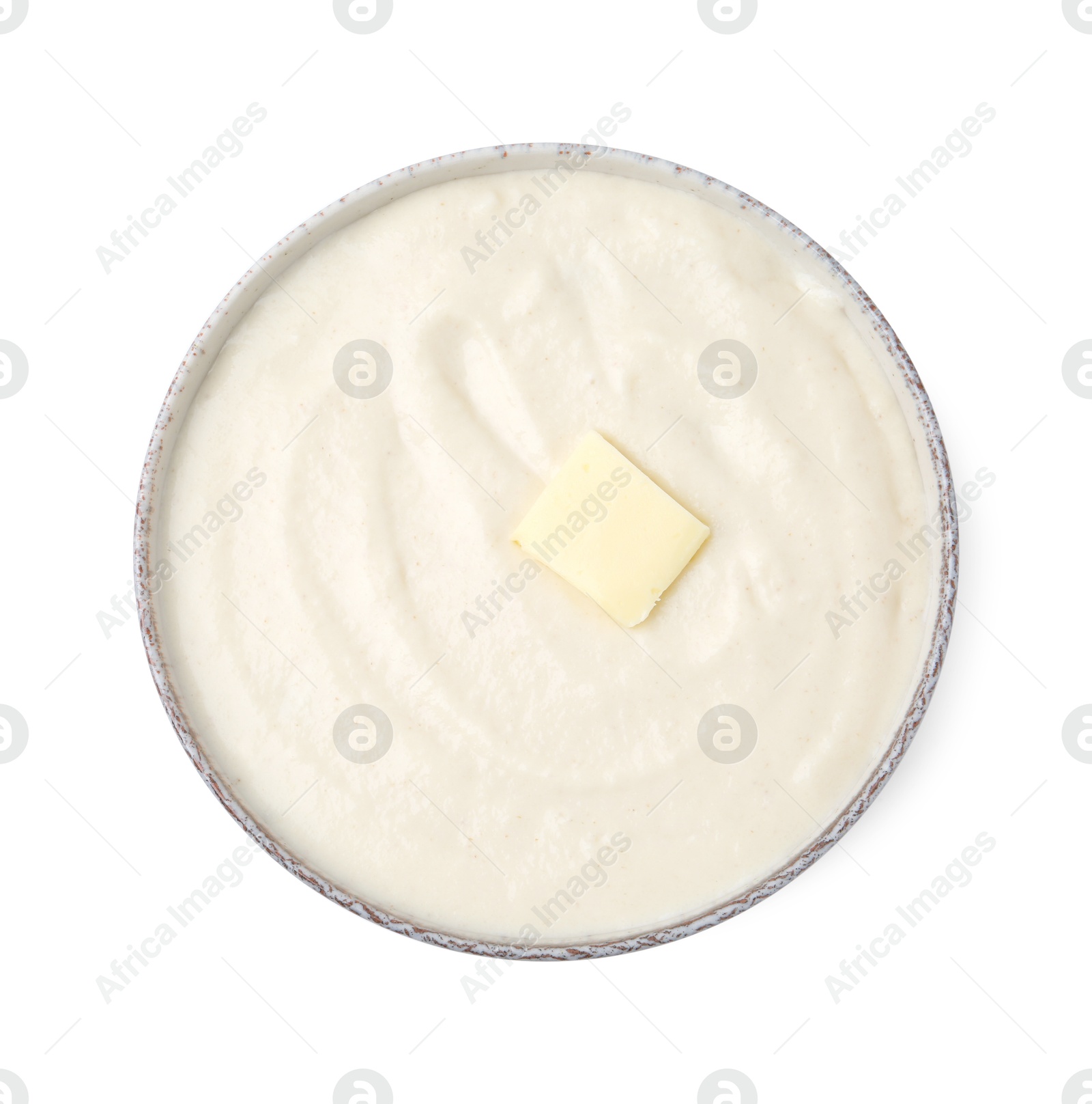 Photo of Tasty cooked semolina porridge with butter isolated on white, top view