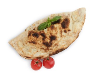 One delicious calzone with fresh basil and tomatoes isolated on white, top view