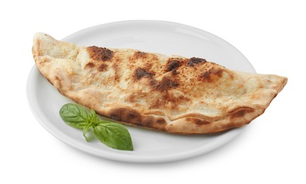 One delicious calzone with fresh basil isolated on white