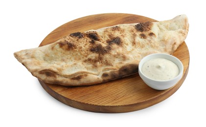 Photo of One delicious calzone with sauce isolated on white