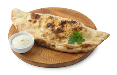 Photo of Delicious calzone with sauce and parsley isolated on white