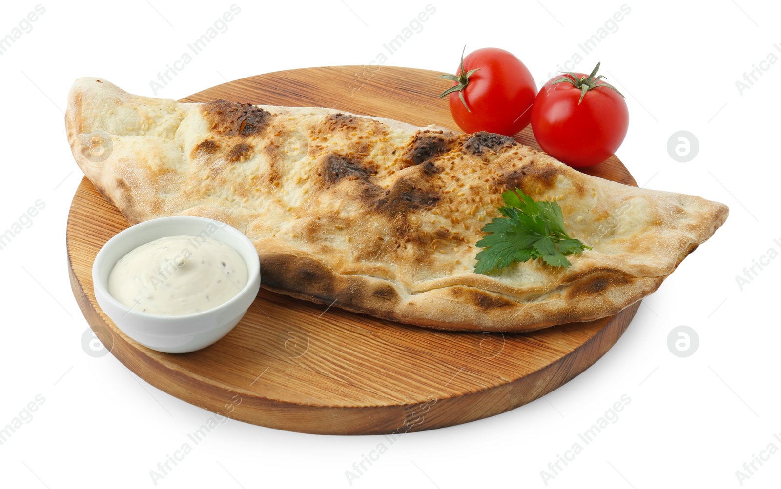 Photo of Delicious calzone with sauce, fresh tomatoes and parsley isolated on white