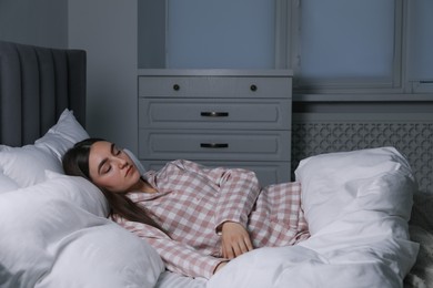 Photo of Young woman suffering from sleepwalking on bed at home