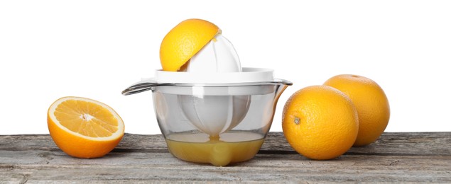 Photo of Plastic juicer and fresh oranges on wooden table against white background