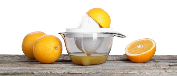 Photo of Plastic juicer and fresh oranges on wooden table against white background