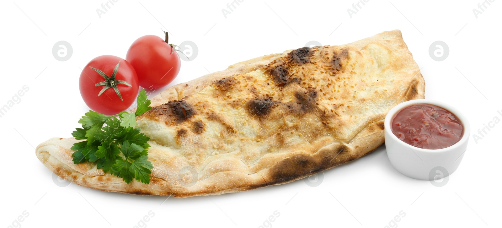 Photo of Delicious calzone with fresh parsley, tomatoes and ketchup isolated on white