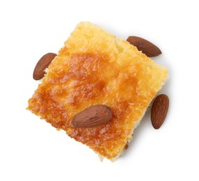 Photo of Slice of tasty semolina cake and almonds isolated on white, top view