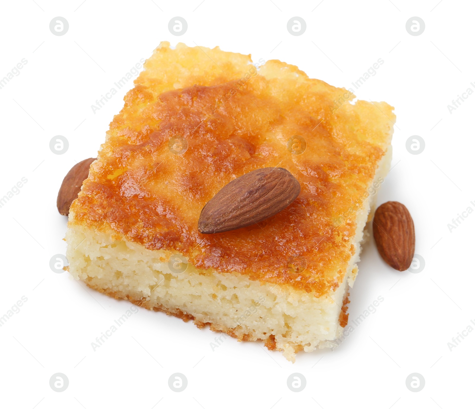 Photo of Slice of tasty semolina cake and almonds isolated on white