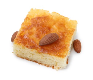 Photo of Slice of tasty semolina cake and almonds isolated on white