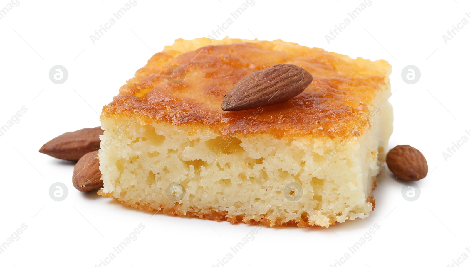 Photo of Slice of tasty semolina cake and almonds isolated on white