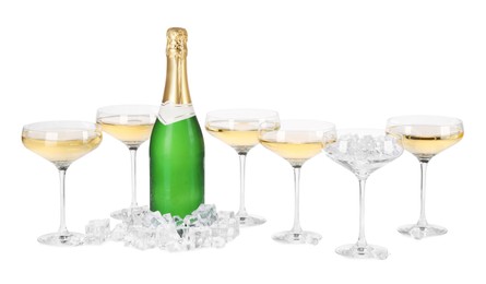 Photo of Bottle and glasses of champagne with ice cubes isolated on white