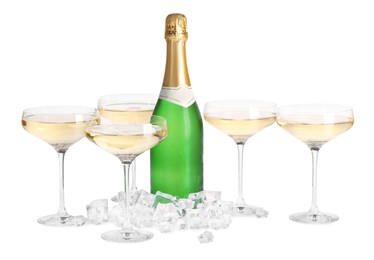 Photo of Bottle and glasses of champagne with ice cubes isolated on white