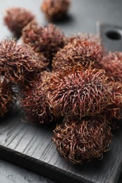 Many delicious ripe rambutans on table, closeup