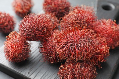 Photo of Many delicious ripe rambutans on table, closeup