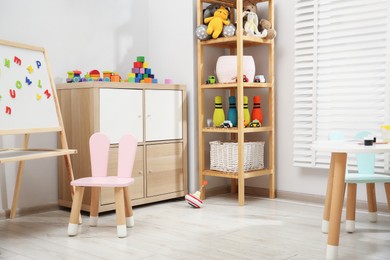 Photo of Table with paints and different toys in child's room