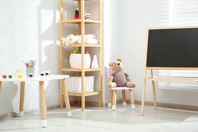 Photo of Beautiful child's room interior with toys and stylish furniture