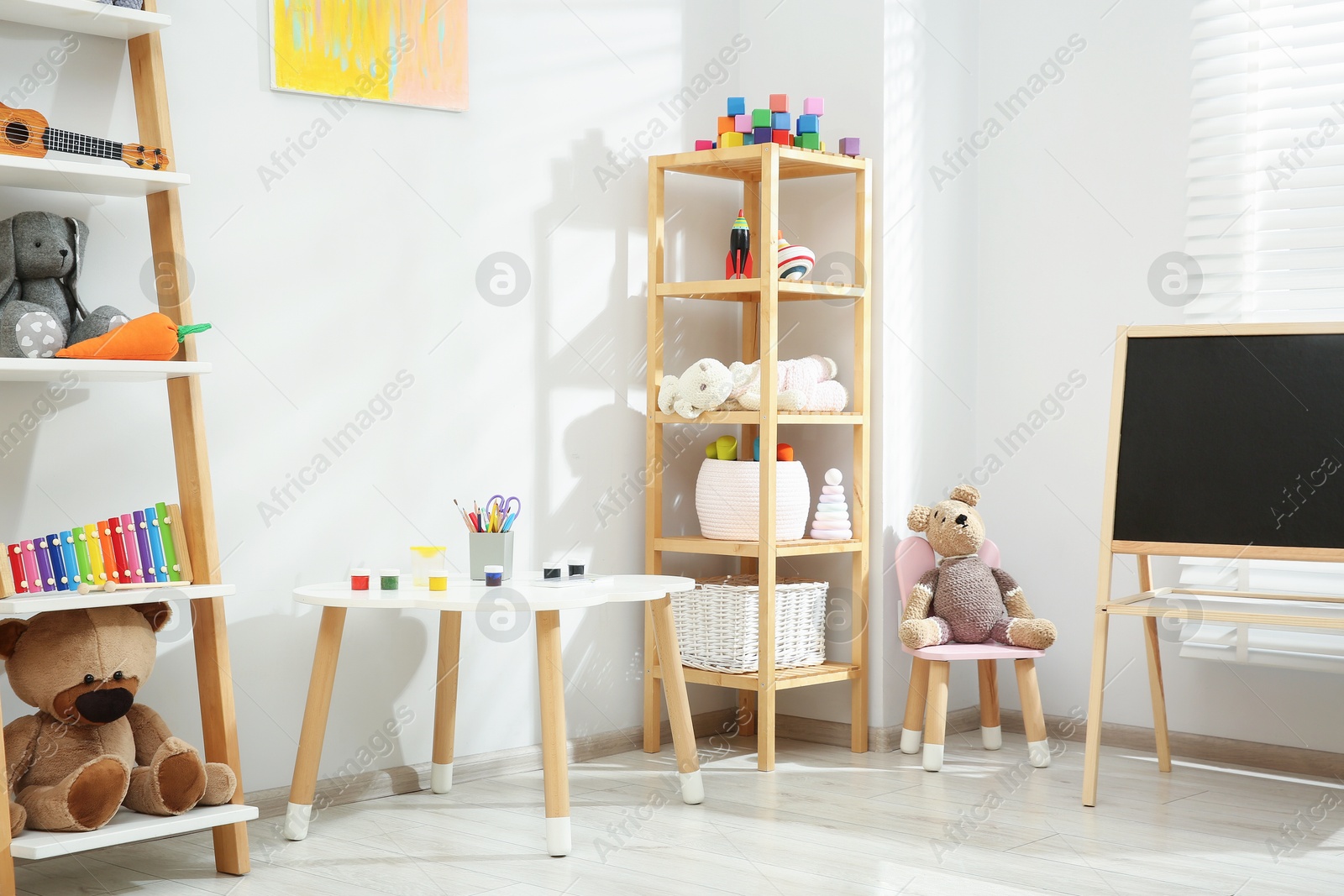 Photo of Beautiful child's room interior with toys and stylish furniture