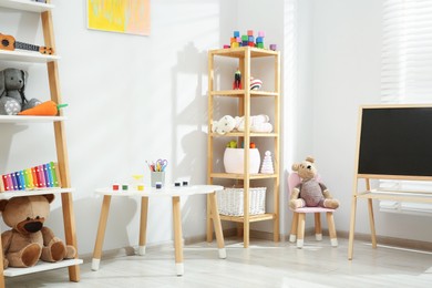 Photo of Beautiful child's room interior with toys and stylish furniture