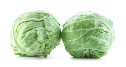 Photo of Two whole heads of cabbage isolated on white