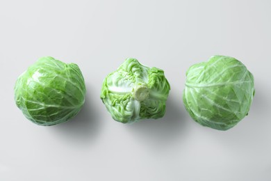 Photo of Raw green cabbages on white background, flat lay