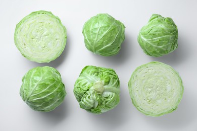 Photo of Raw green cabbages on white background, flat lay