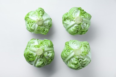 Photo of Raw green cabbages on white background, flat lay