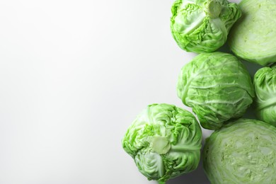 Photo of Raw green cabbages on white background, flat lay. Space for text