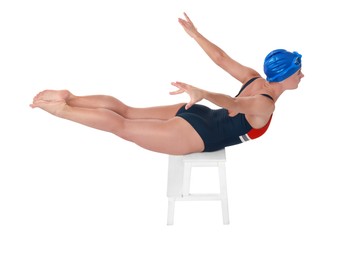 Professional sportswoman in swimsuit and cap swimming on white background