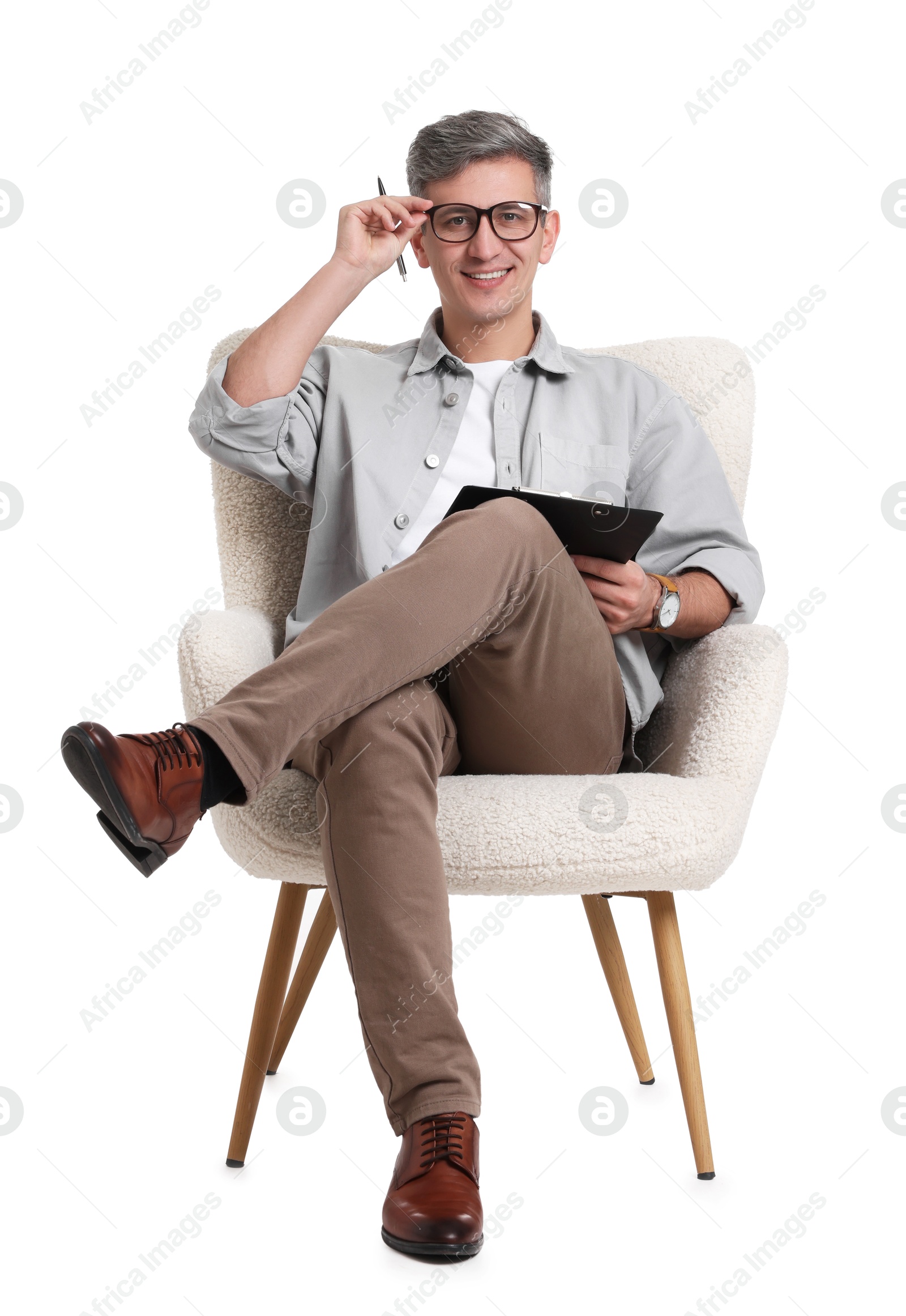 Photo of Professional psychologist with clipboard sitting on chair against white background