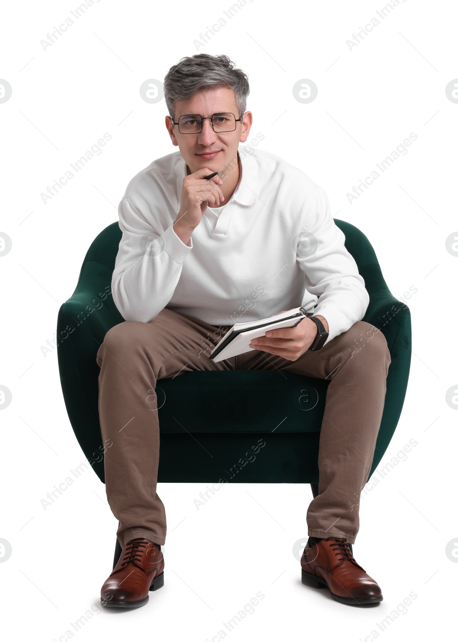 Photo of Professional psychologist with notebook sitting on chair against white background