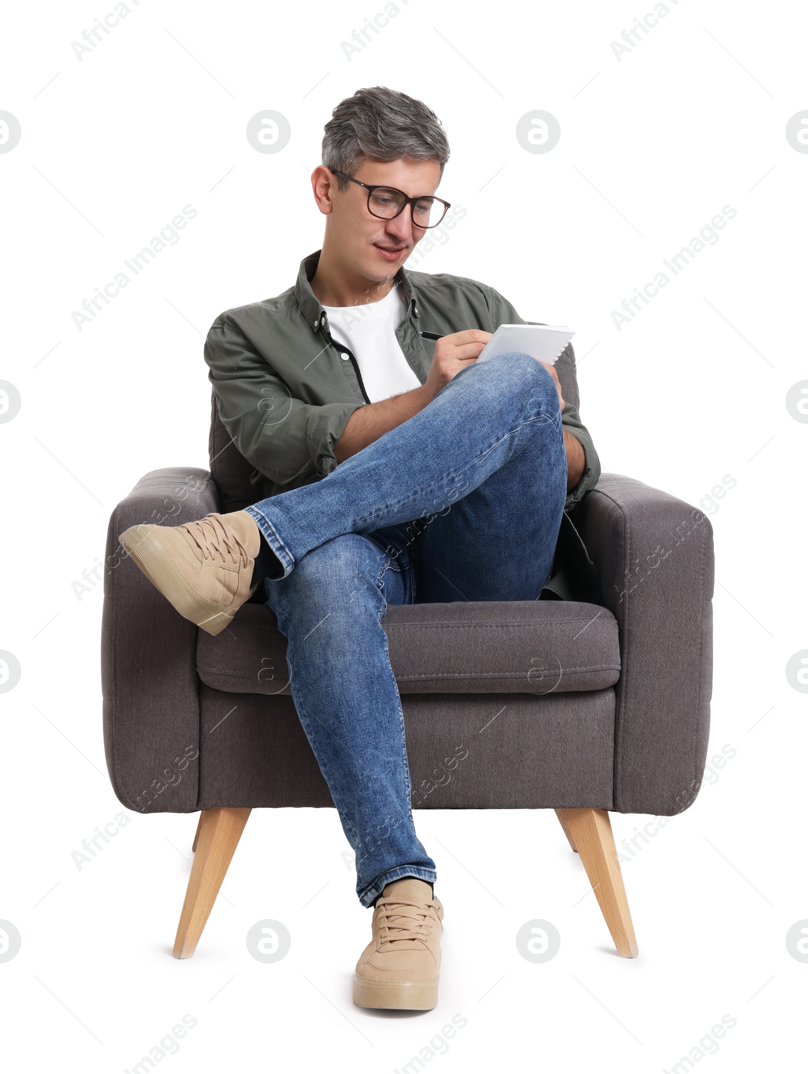 Photo of Professional psychologist with notebook sitting on chair against white background