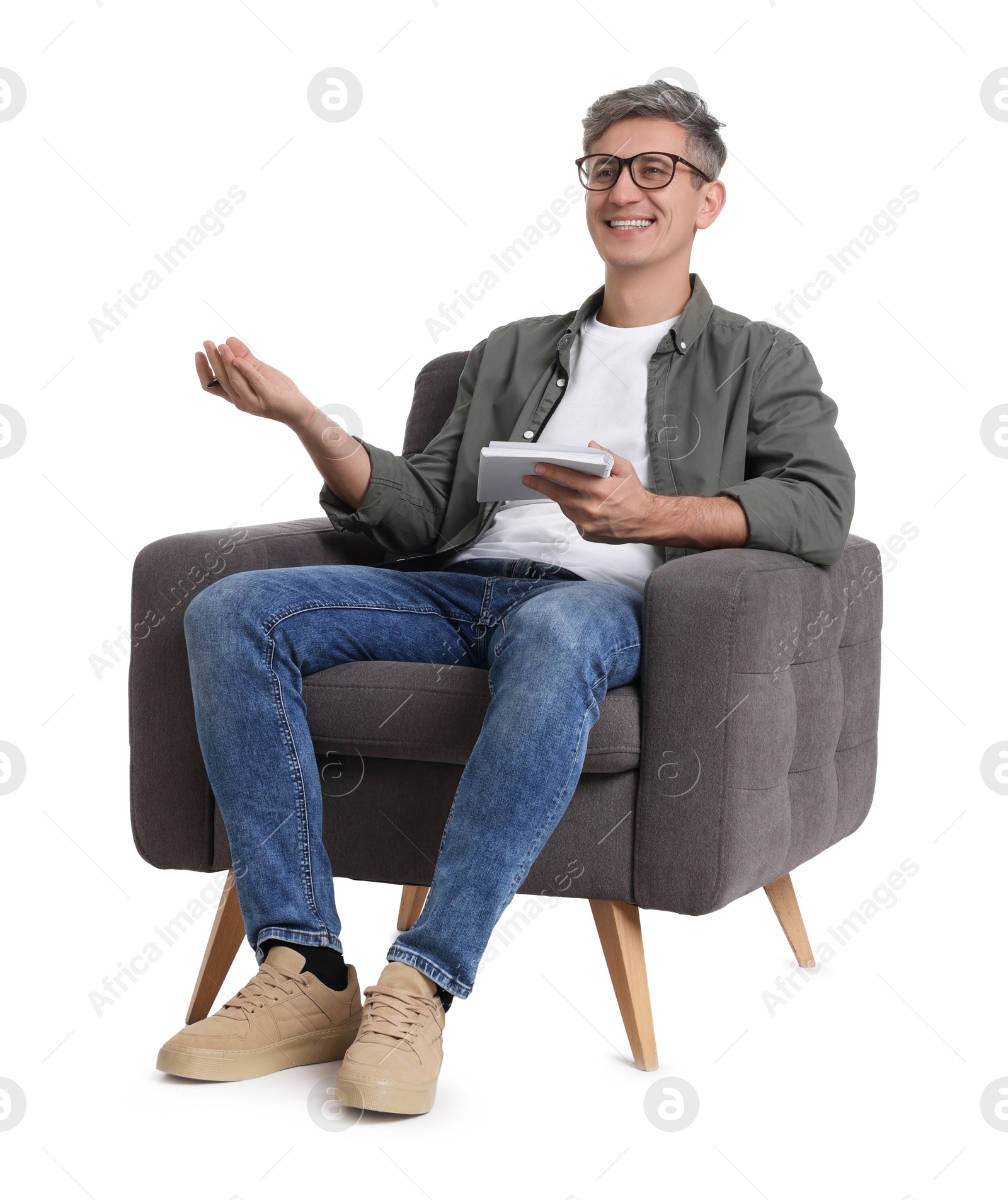 Photo of Professional psychologist with notebook sitting on chair against white background