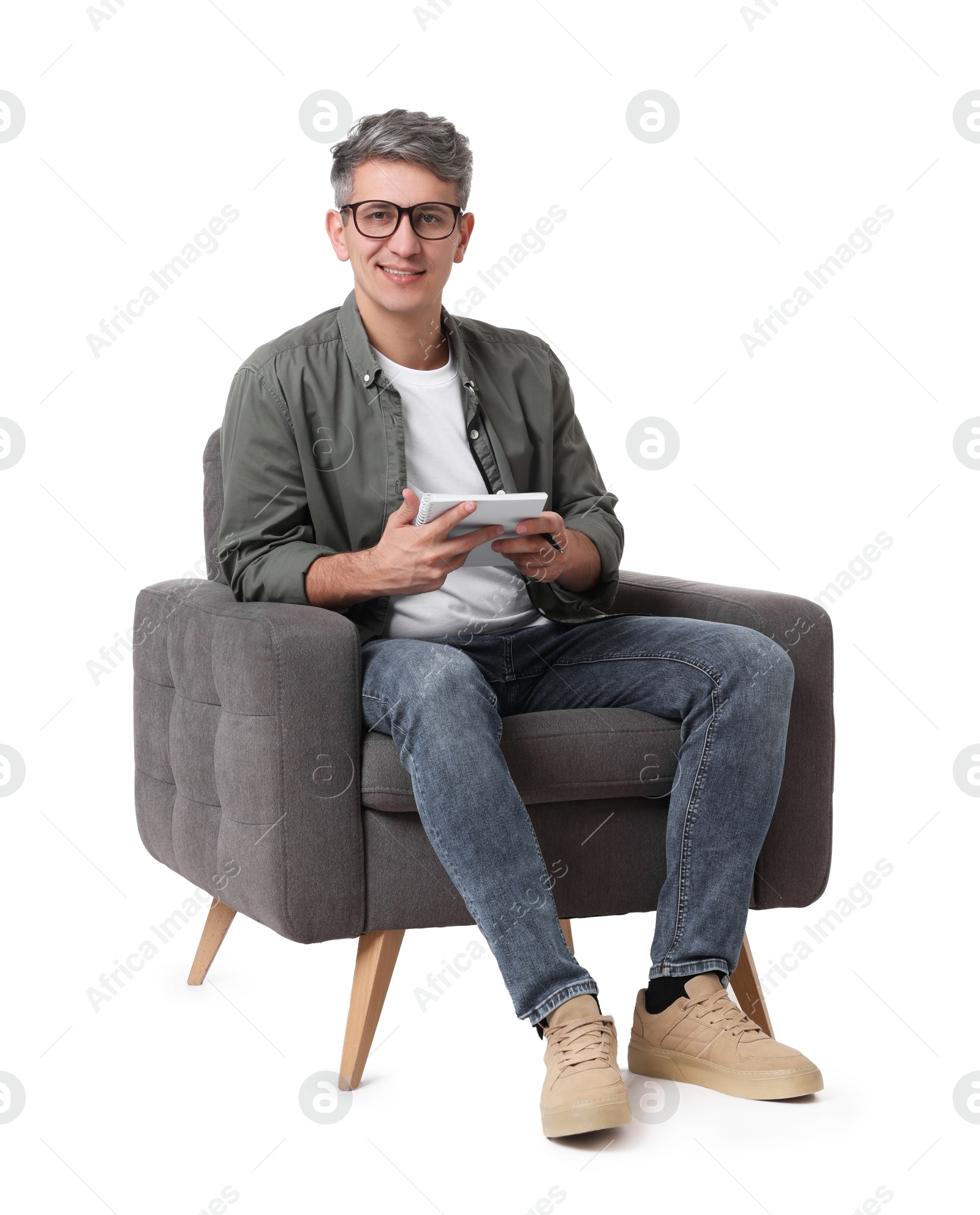 Photo of Professional psychologist with notebook sitting on chair against white background