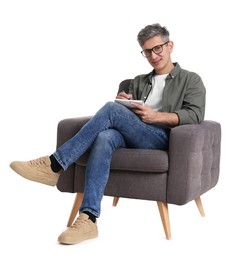 Professional psychologist with notebook sitting on chair against white background