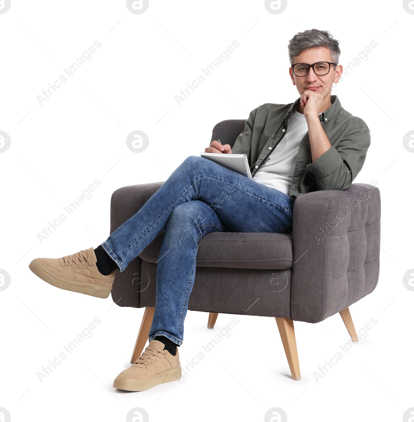 Photo of Professional psychologist with notebook sitting on chair against white background