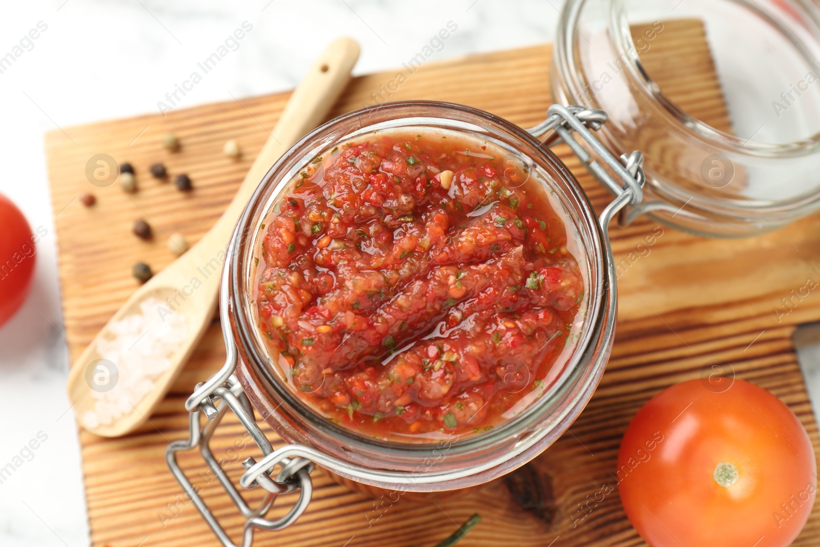 Photo of Spicy salsa and ingredients on white table, above view