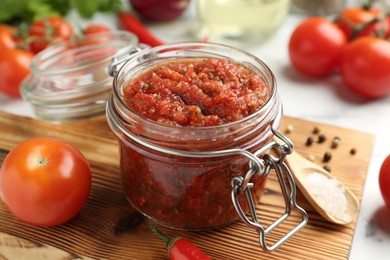 Photo of Spicy salsa and ingredients on table, closeup