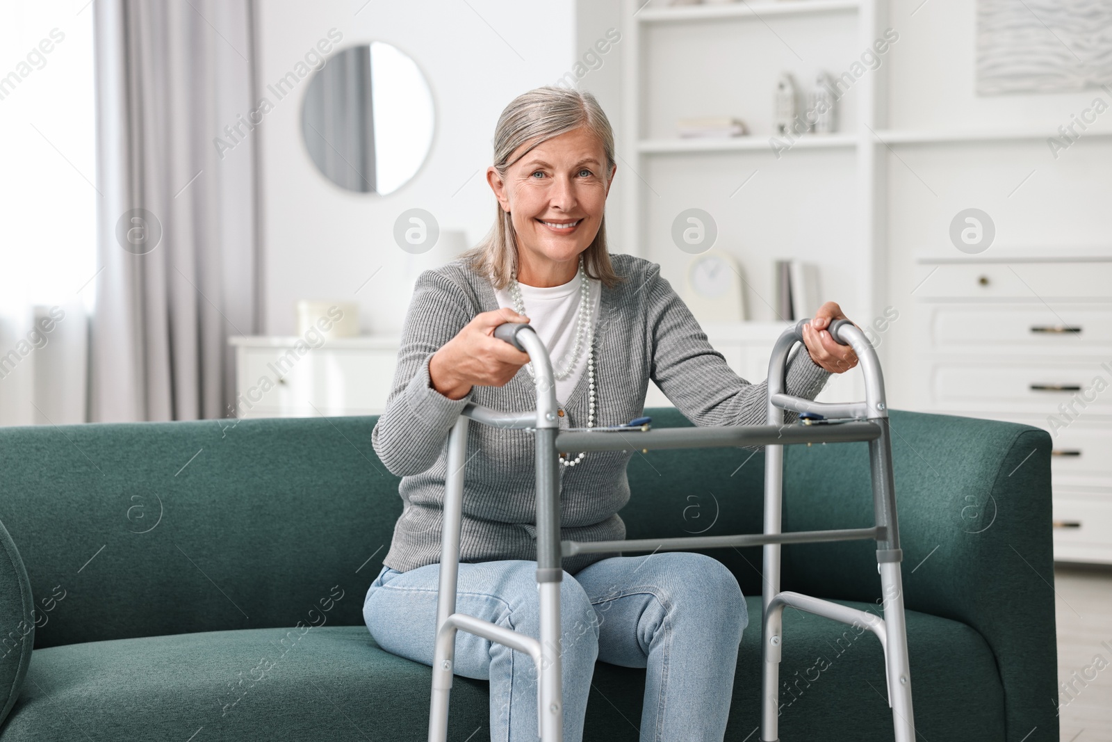 Photo of Senior woman with walking frame on sofa at home