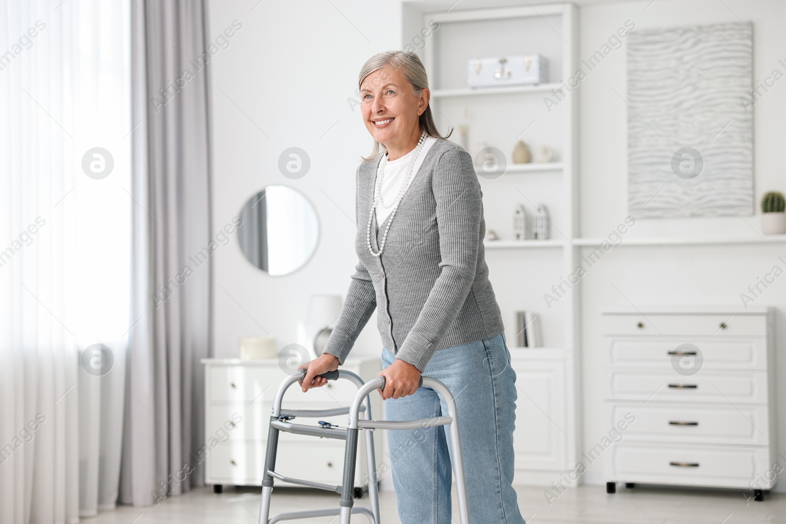 Photo of Senior woman with walking frame at home