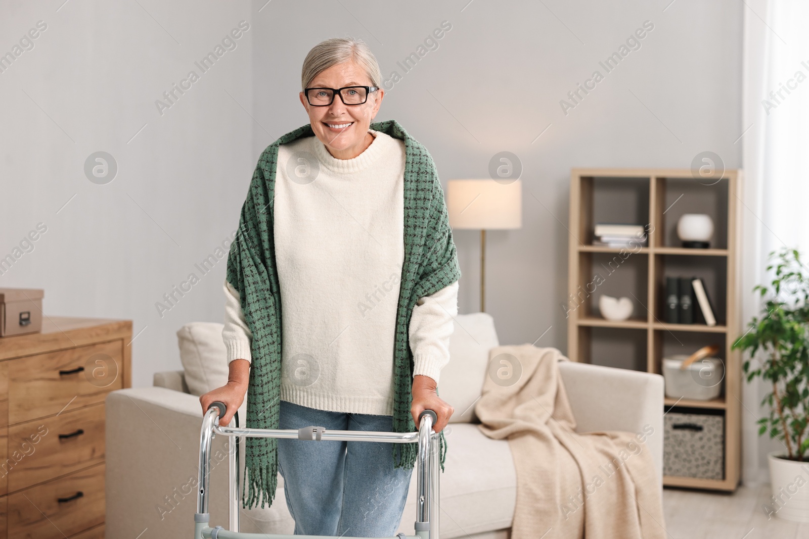 Photo of Senior woman with walking frame at home