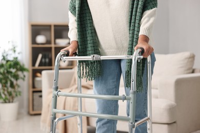 Photo of Senior woman with walking frame at home, closeup