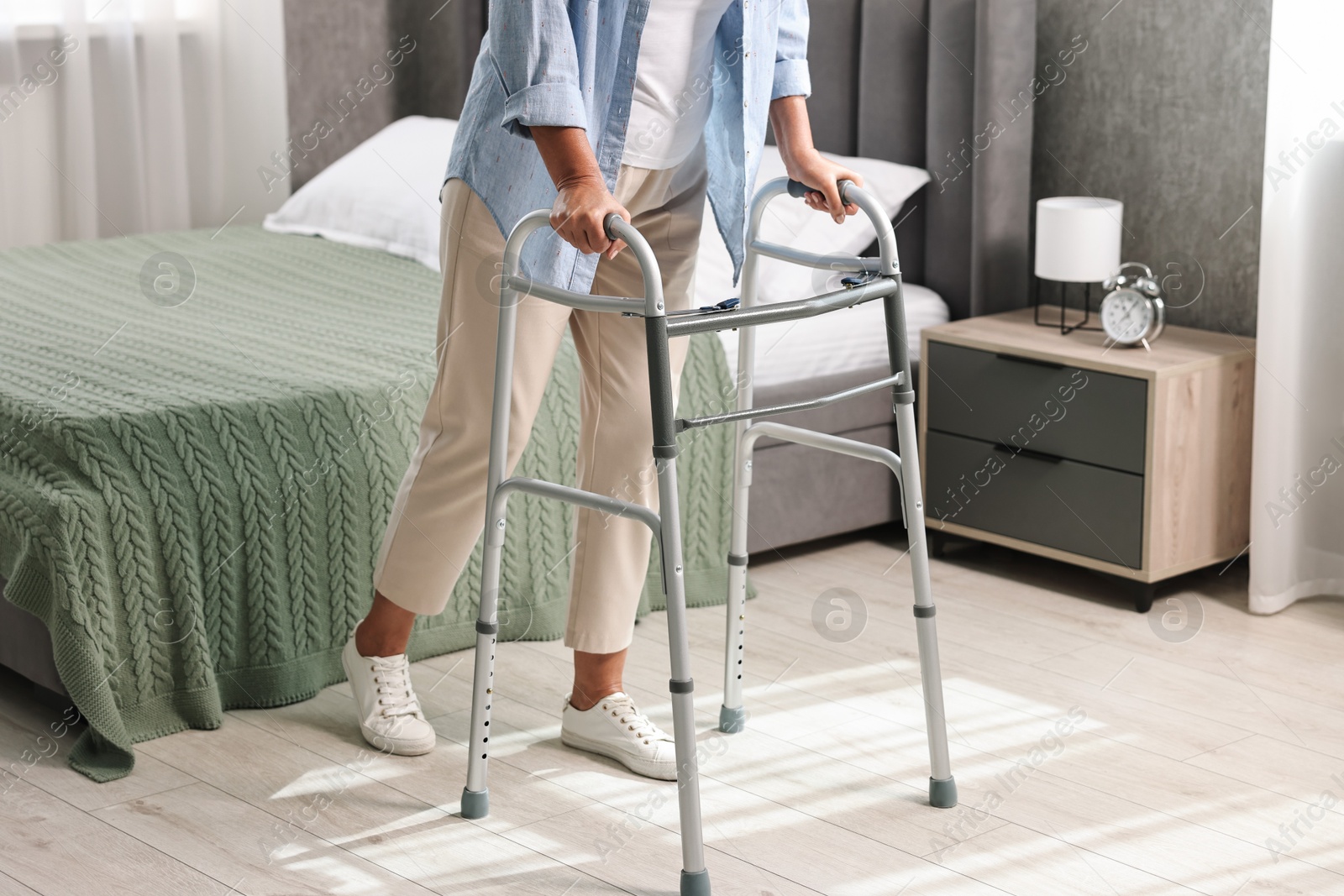 Photo of Senior woman with walking frame at home, closeup