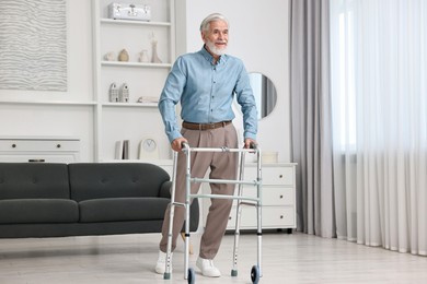 Photo of Senior man using walking frame at home