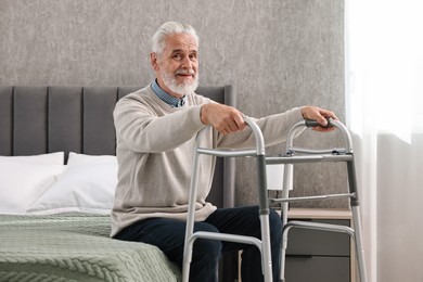 Photo of Senior man with walking frame on bed at home